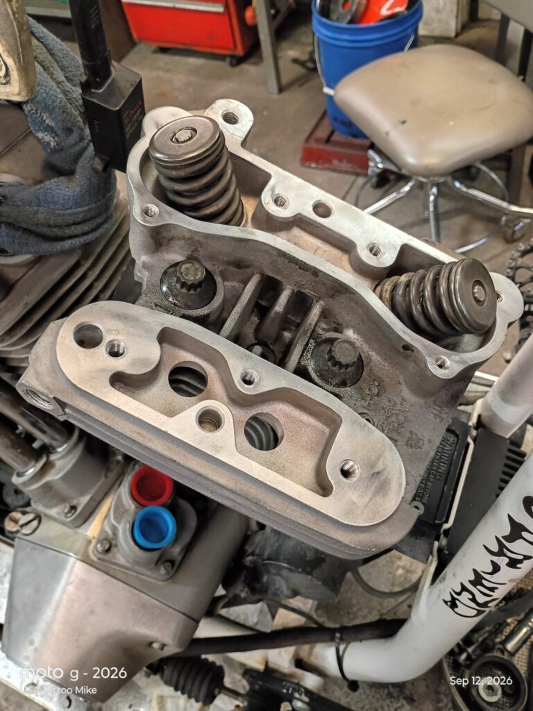 Cylinder head with the rocker box off and valve springs exposed during a valve job