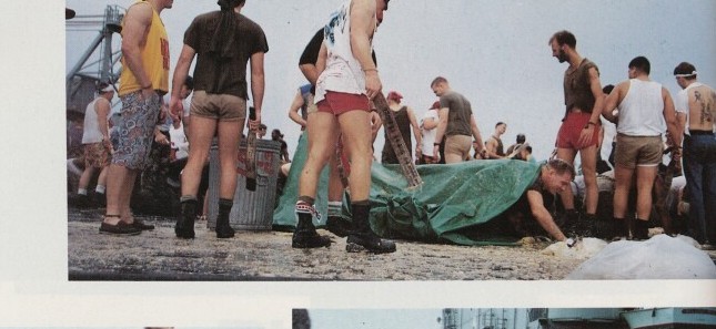 Pollywogs crawling the flight deck during the Crossing the Line ceremony aboard USS Belleau Wood, 1989
